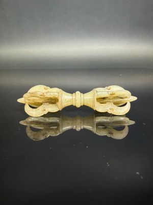 a close up of a wooden bow on a black surface