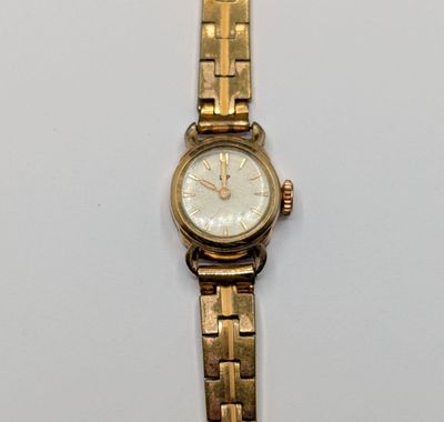 an image of a close up of a wrist watch on a white surface