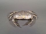 a silver crab that is sitting on a table