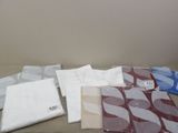 a lot of different types of bed sheets on the bed