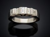 a close up of a diamond ring on a black surface
