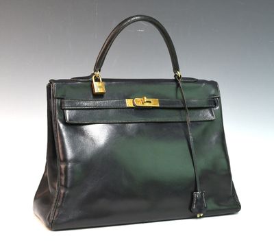 an image of a black and green leather handbag on a white surface