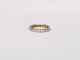 a gold ring with diamonds on a white background