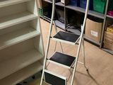 a ladder that is standing next to a book shelf