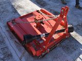 a red machine that is sitting on the ground