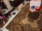 a living room with a rug and a chair in it