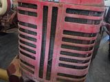 a red tractor that is sitting in a garage