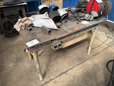 a table with a lot of tools on it in a garage