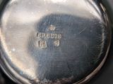 an image of a close up of a silver plate with a clock on it