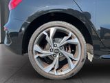 a close up of a car ' s wheel on the street