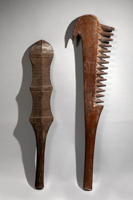 pair of wooden combs on a white background with a shadow