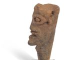 statue of a man ' s head on a stand on a white surface