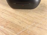 a black computer mouse sitting on a wooden table