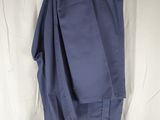 a pair of pants hanging on a hanger on a bed