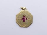 an image of a small gold medal with a cross on it