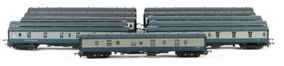 three blue and white train cars sitting next to each other on a white surface
