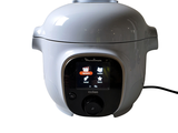 a white rice cooker sitting on a white surface