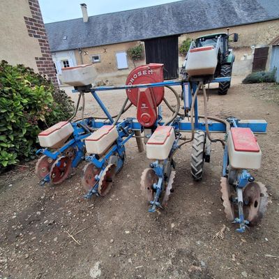an image of a tractor with a seeder attached to it