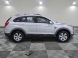 a picture of a white suv parked in a garage