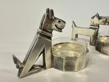 a silver dog and a glass of wine on a table