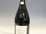 the bottle of red wine is sitting on the table