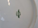 a white plate with a green design on it