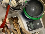 pots and pans and utensils are on a counter in a kitchen