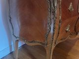 a wooden cabinet with a marble top on a hard wood floor