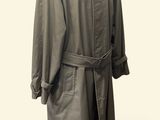 trench coat on a mannequin stand on a white background
