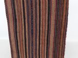 a close up of a striped blanket on a white surface