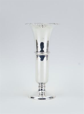 an image of a silver vase sitting on top of a white table