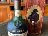 a bottle of liquor sitting on a table next to a box