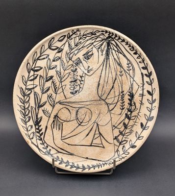 a black and white plate with an image of a woman holding a child