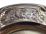 a silver plate with a design on it