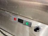 an image of a stainless steel oven with a green button