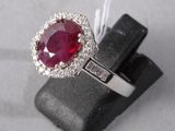 an image of a ring with a ruby stone and diamonds