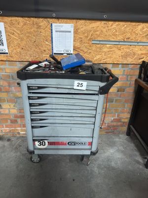 a tool cart with tools on it in a garage