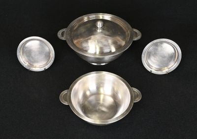 four pieces of silverware sitting on a black surface