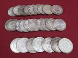 some silver coins on a red cloth with a red background