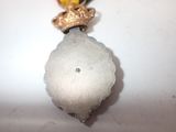 a silver medal with a gold crown on top of it