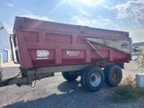 a red dump truck that is parked on the side of the road