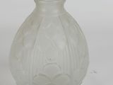 a clear glass vase with a flower design on it