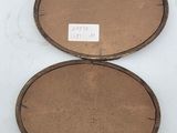 two round wooden trays sitting on top of a white surface