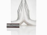 an image of a sculpture of a person with their hands folded in prayer