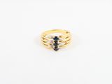 a yellow gold ring with a black and white diamond center