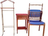 three chairs and a table with a coat rack on it