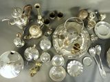 a lot of silver and silverware on a table
