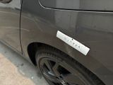 a black car with a sticker on the side of it