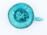 blue ceramic bowl with handle on a white background