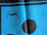 blue and black scarf with black and white polkas on it